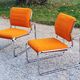 Pair of designer armchairs in orange fabrics and chrome tubes from the 70s