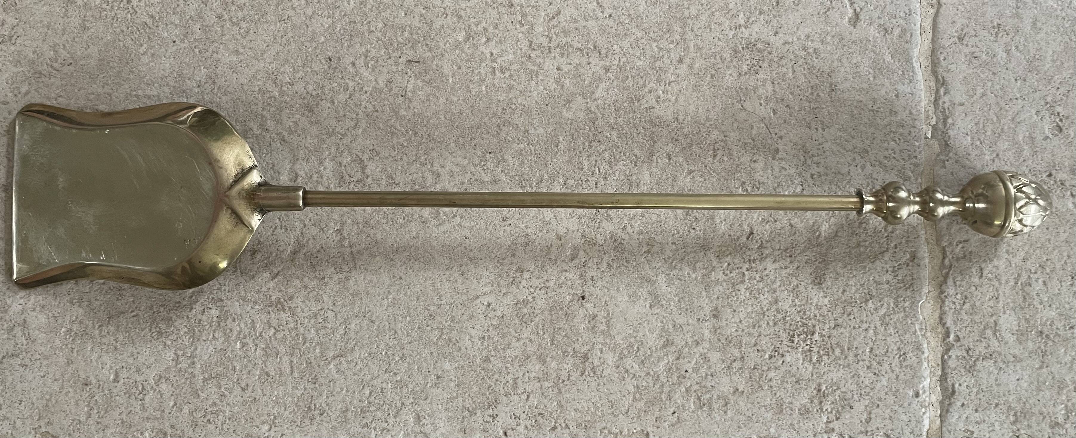 Brass fireplace tools in the style of Maison Baguès.