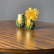 A pair of green and yellow vases
