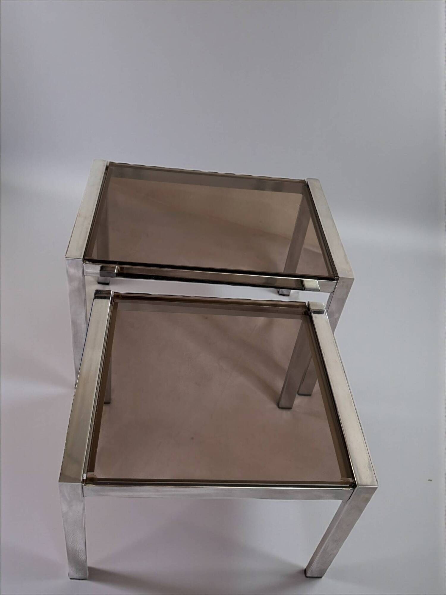 Vintage 1970s nesting tables in chrome and smoked glass, mid-century modernist style