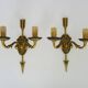 Pair of double-light Empire style arrow wall lights in bronze. Early 20th century