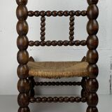 Brutalist wood turned bobbin low rush chair in the style of Charles Dudouyt