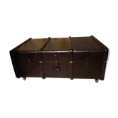 Wooden travel trunk and burlap on wheels as a living room table