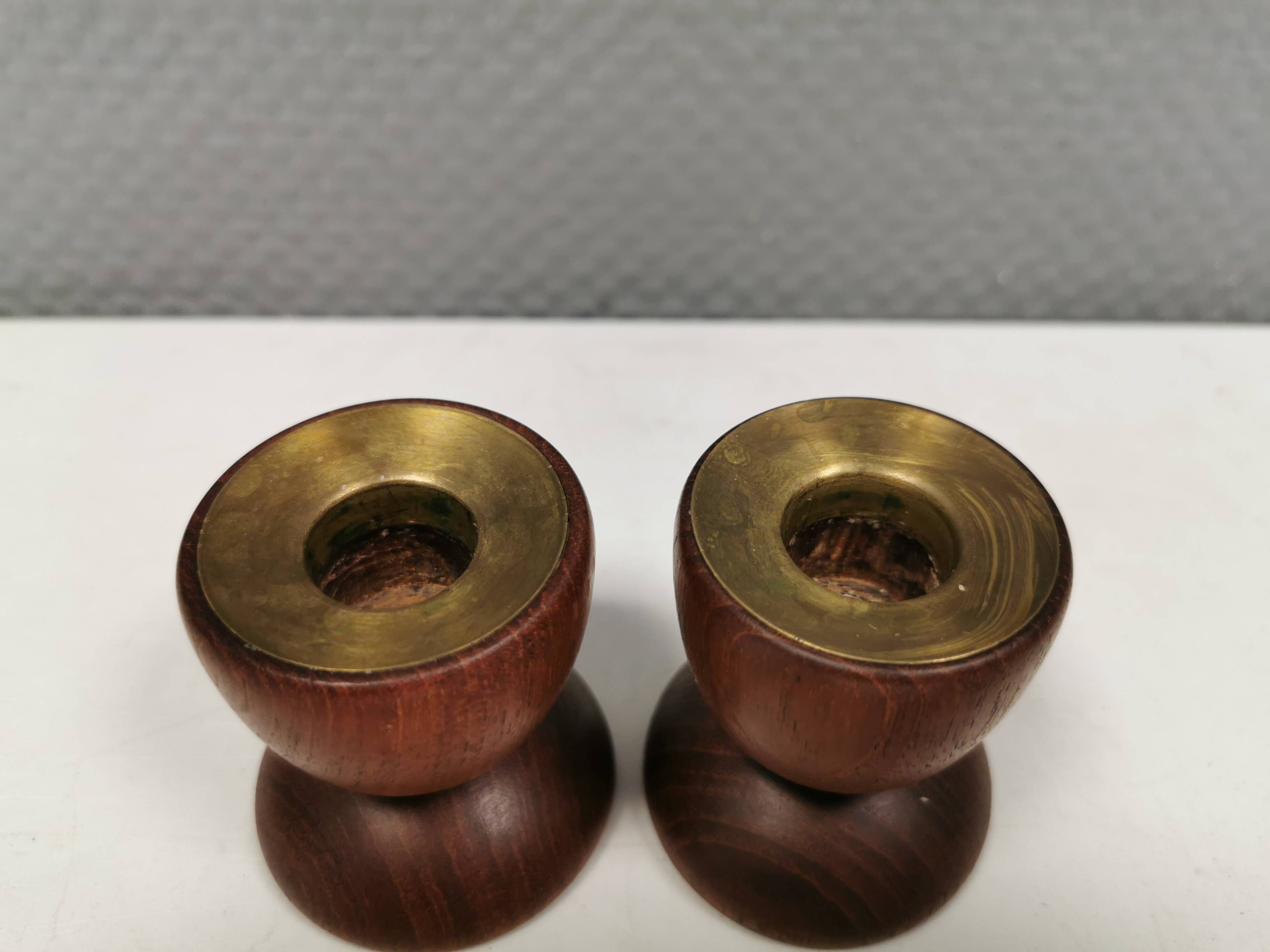 Two beautiful teak candle holders with brass inserts.
