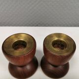 Two beautiful teak candle holders with brass inserts.
