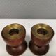 Two beautiful teak candle holders with brass inserts.