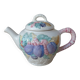 Old ceramic teapot in the shape of a basket of fruits from the garden