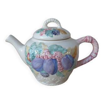 Old ceramic teapot in the shape of a basket of fruits from the garden