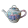 Old ceramic teapot in the shape of a basket of fruits from the garden
