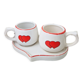 Set of two cups on vintage heart-shaped stoneware tray