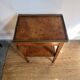 Occasional table in walnut burl and brass gallery.