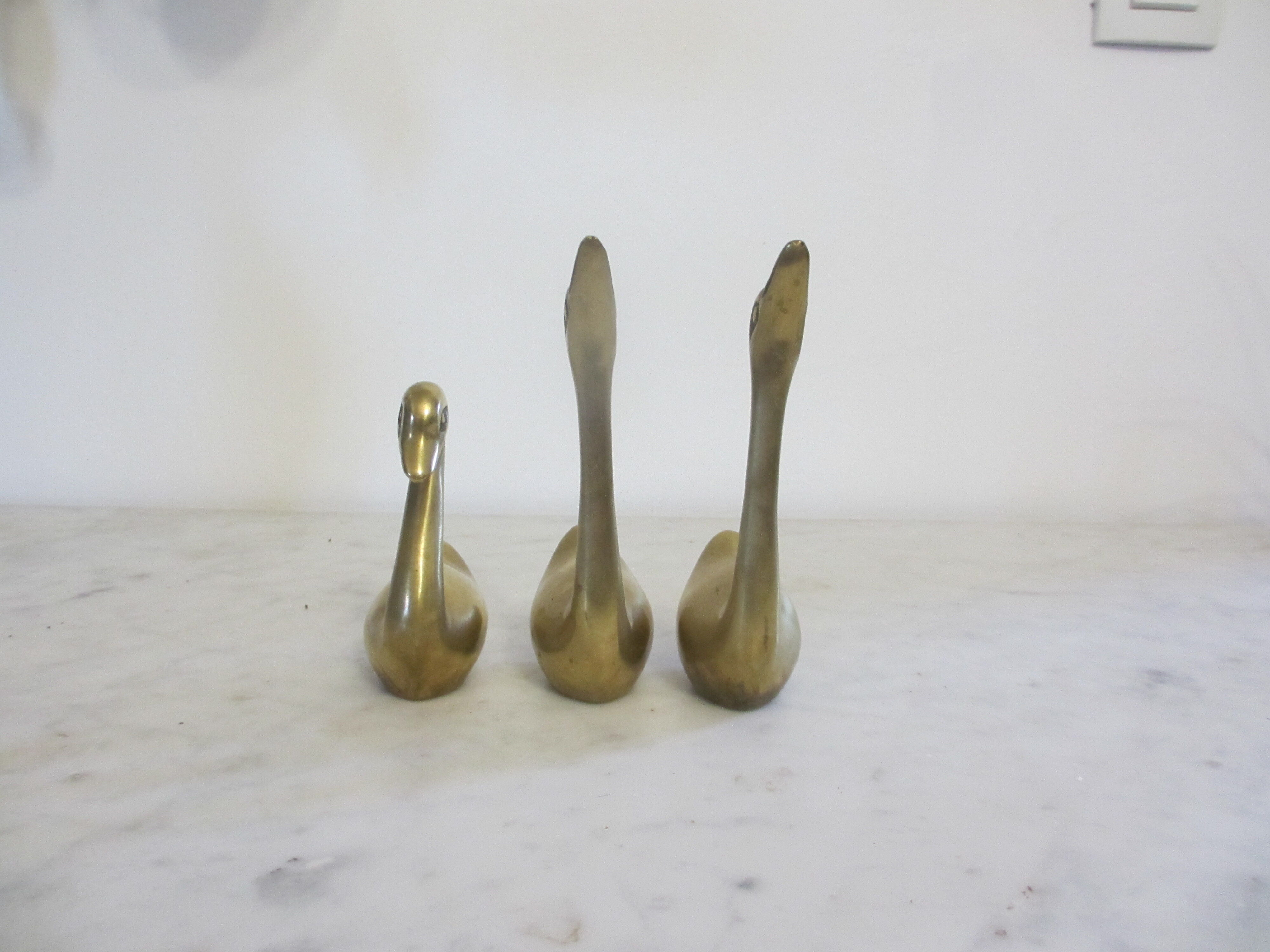 golden brass swans