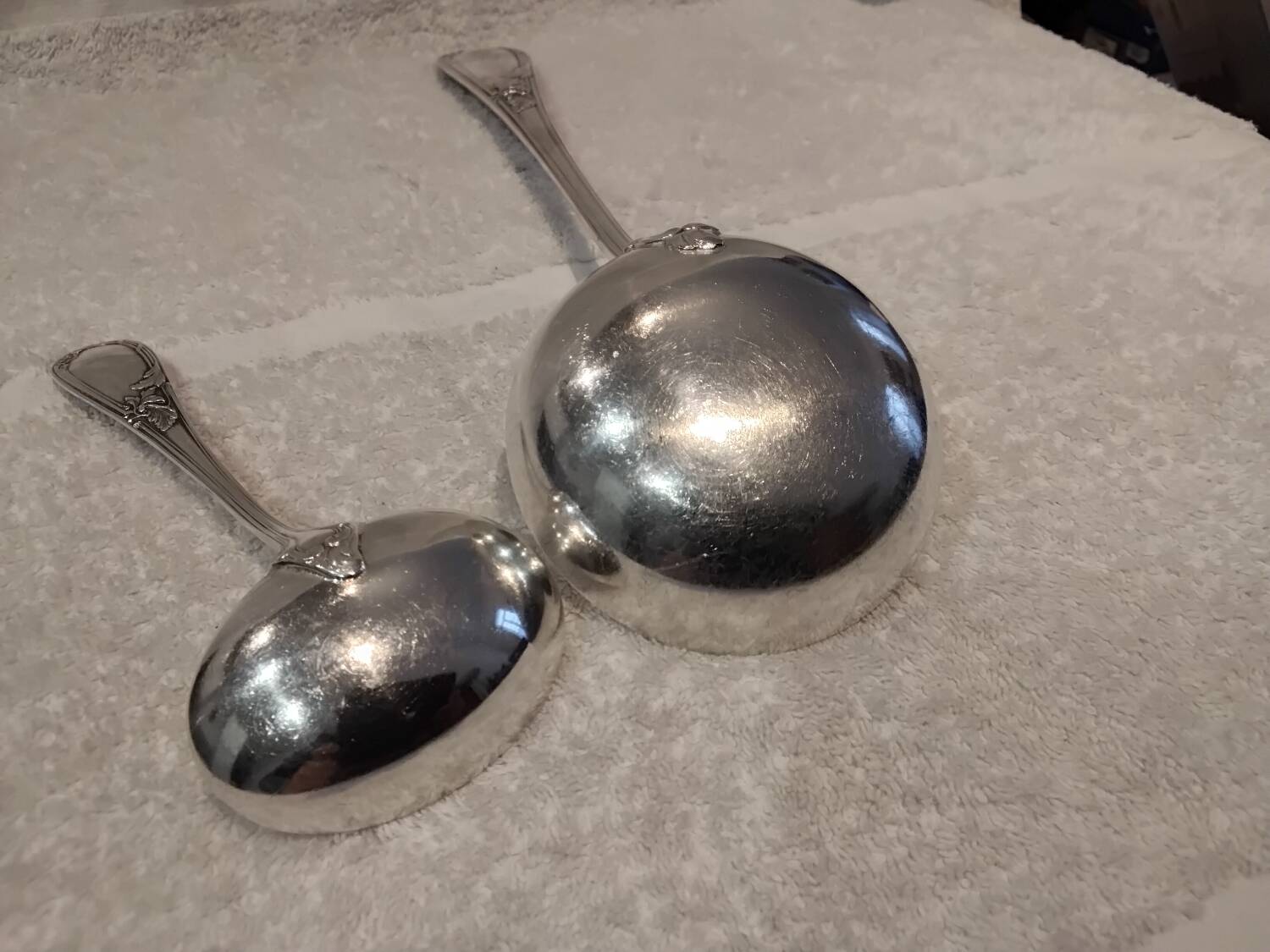 2 Silver-plated soup and sauce ladles with rocaille ribbon decoration
