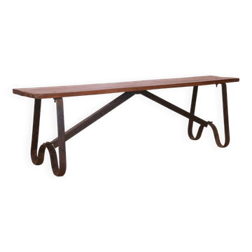 Old bench in Burmese teak with a wrought iron base.