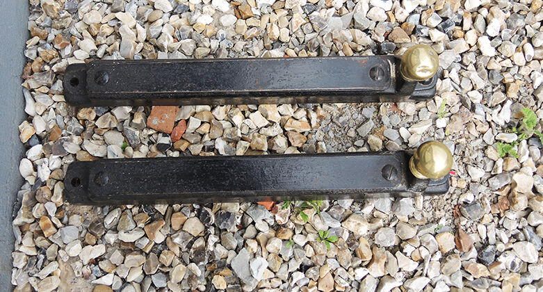 Old cast iron and xl brass andirons in neo classical style