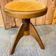 Adjustable vintage piano stool made of wood and velvet