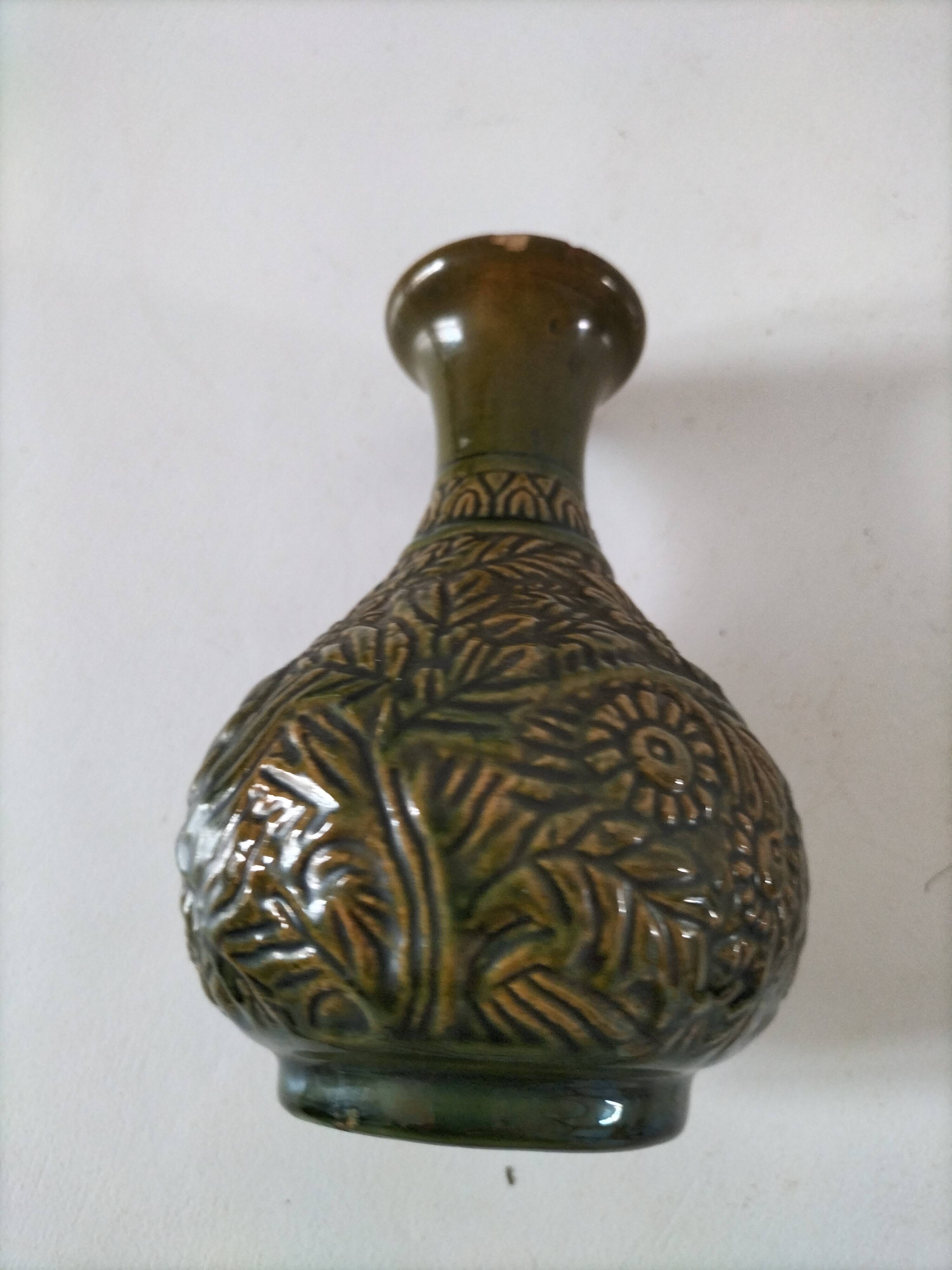Small glazed vase with raised floral decoration