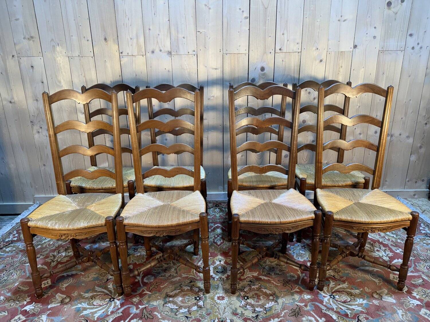 Set of 8 rustic high-back straw chairs.