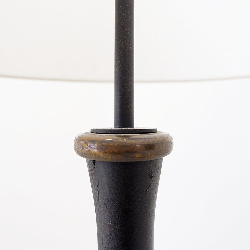 Tripod floor lamp in wrought iron and brass with bamboo-style base.