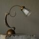 Sculptural table lamp in brass and opaline glass, early 20th century.