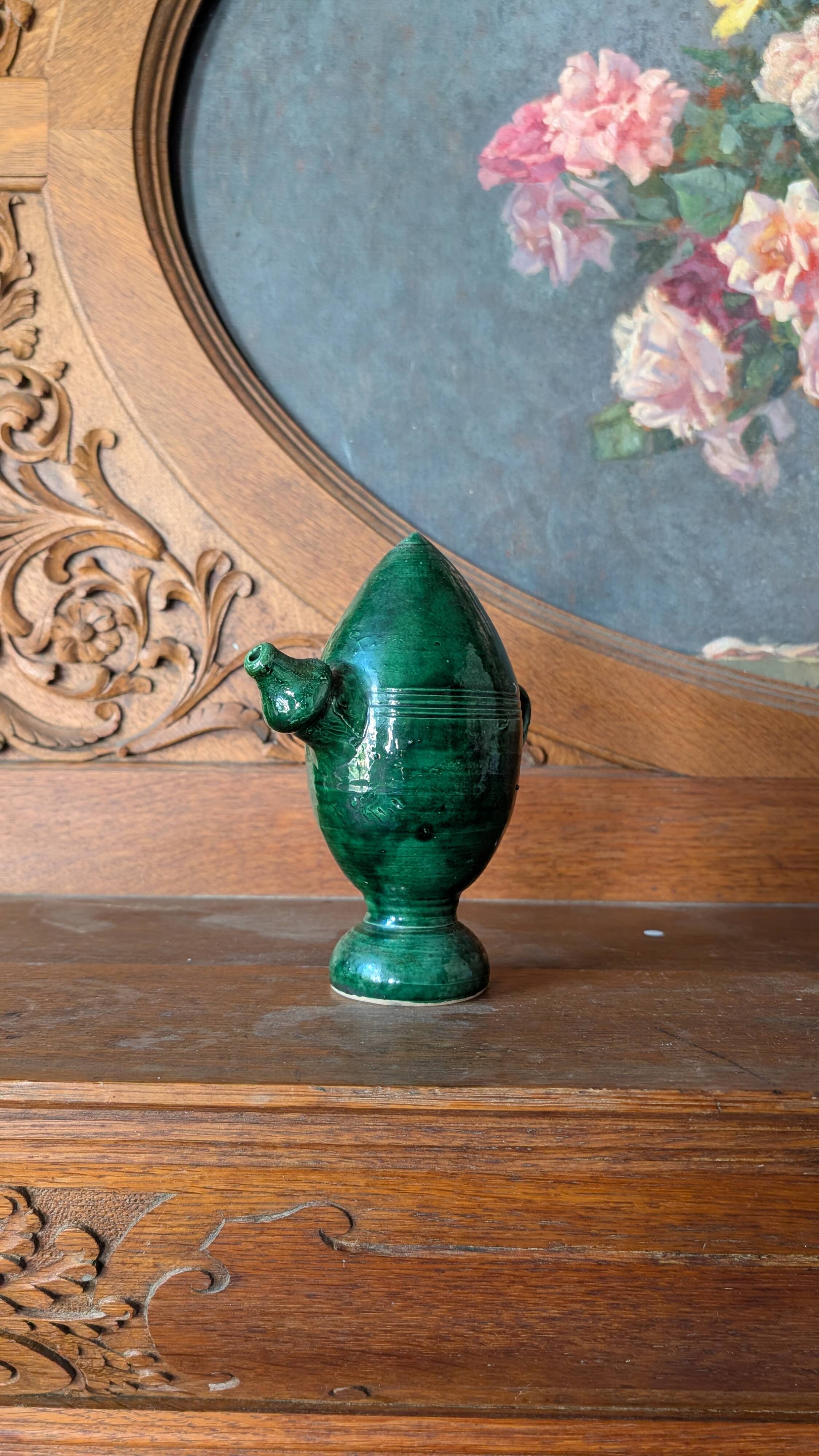 Decorative piece in green glazed stoneware, jug shape.