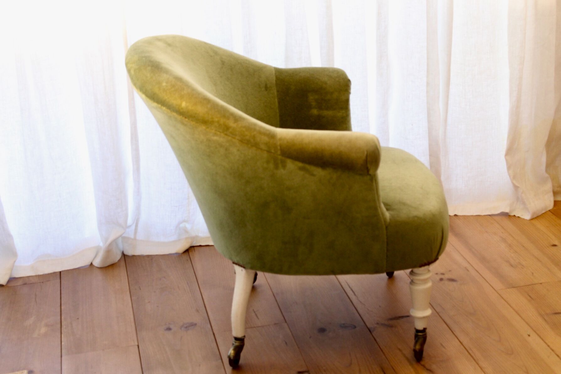 Toad in almond green velvet armchair on castors