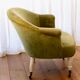 Toad in almond green velvet armchair on castors