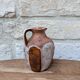 Old small pitcher in glazed terracotta
