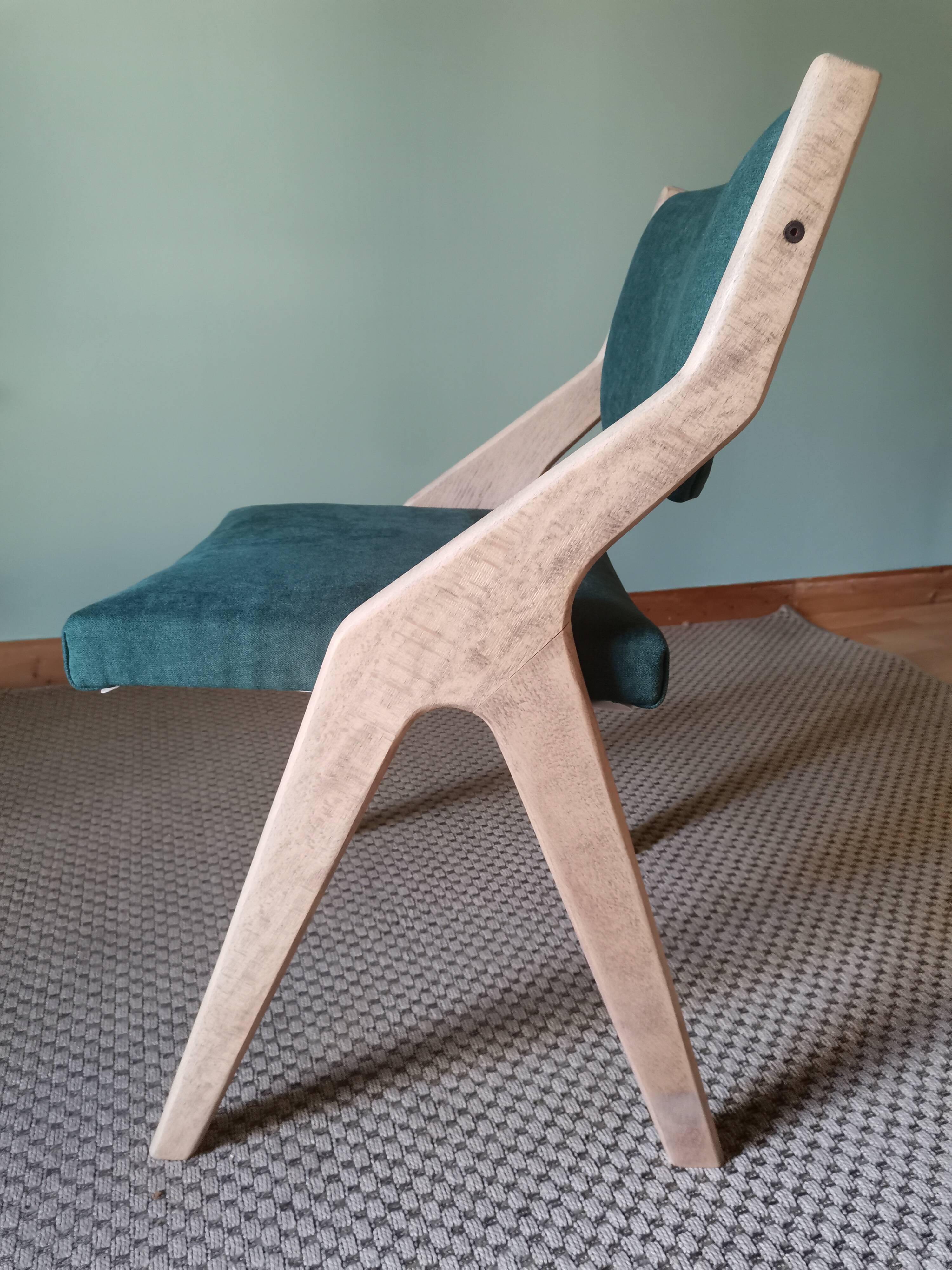 Scandinavian green chairs with tapered legs.