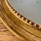 Antique gilded oval mirror