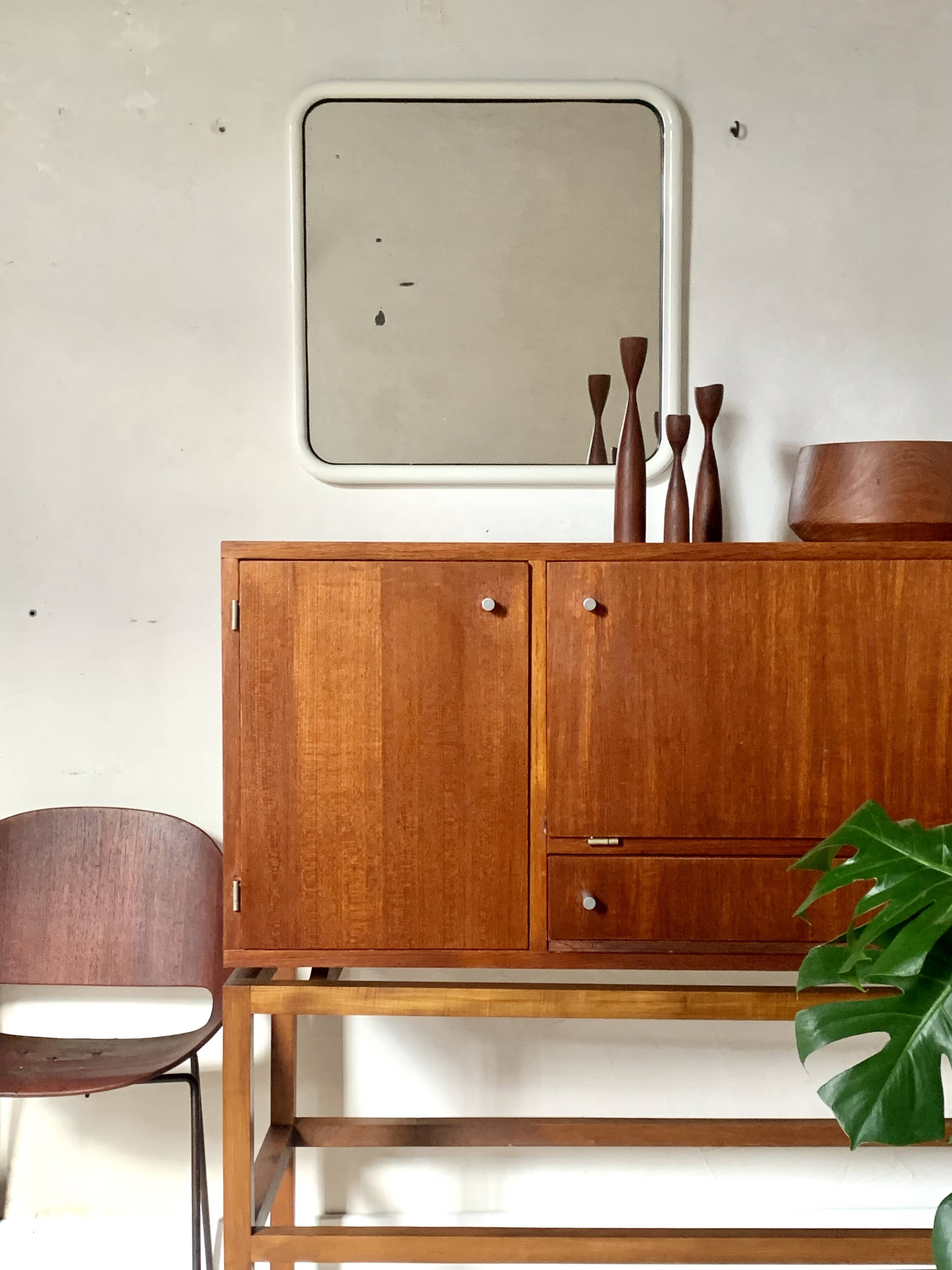White tubular metal wall mirror