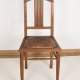 Art Deco style chair in carved wood and leather.