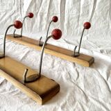 Pair of vintage wooden wall coat racks with three red ball hooks