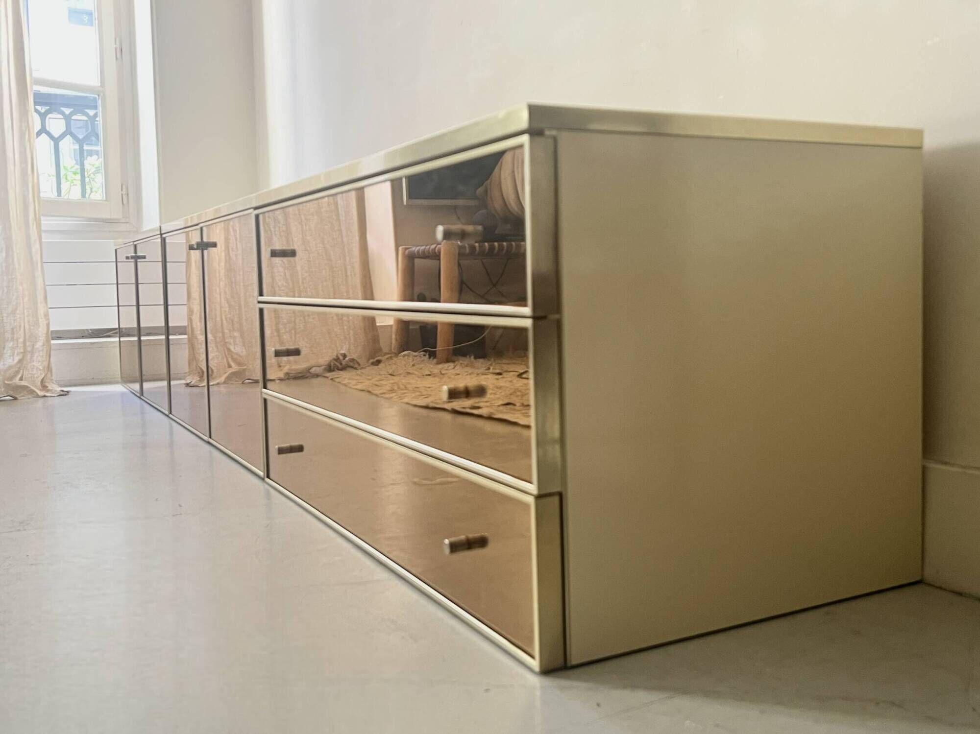 Low ivory lacquered enfilade, smoked mirror & brass JC Mahey, design 1970.