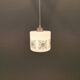 Scandinavian hanging lamp in white glass with inlayed black motifs.