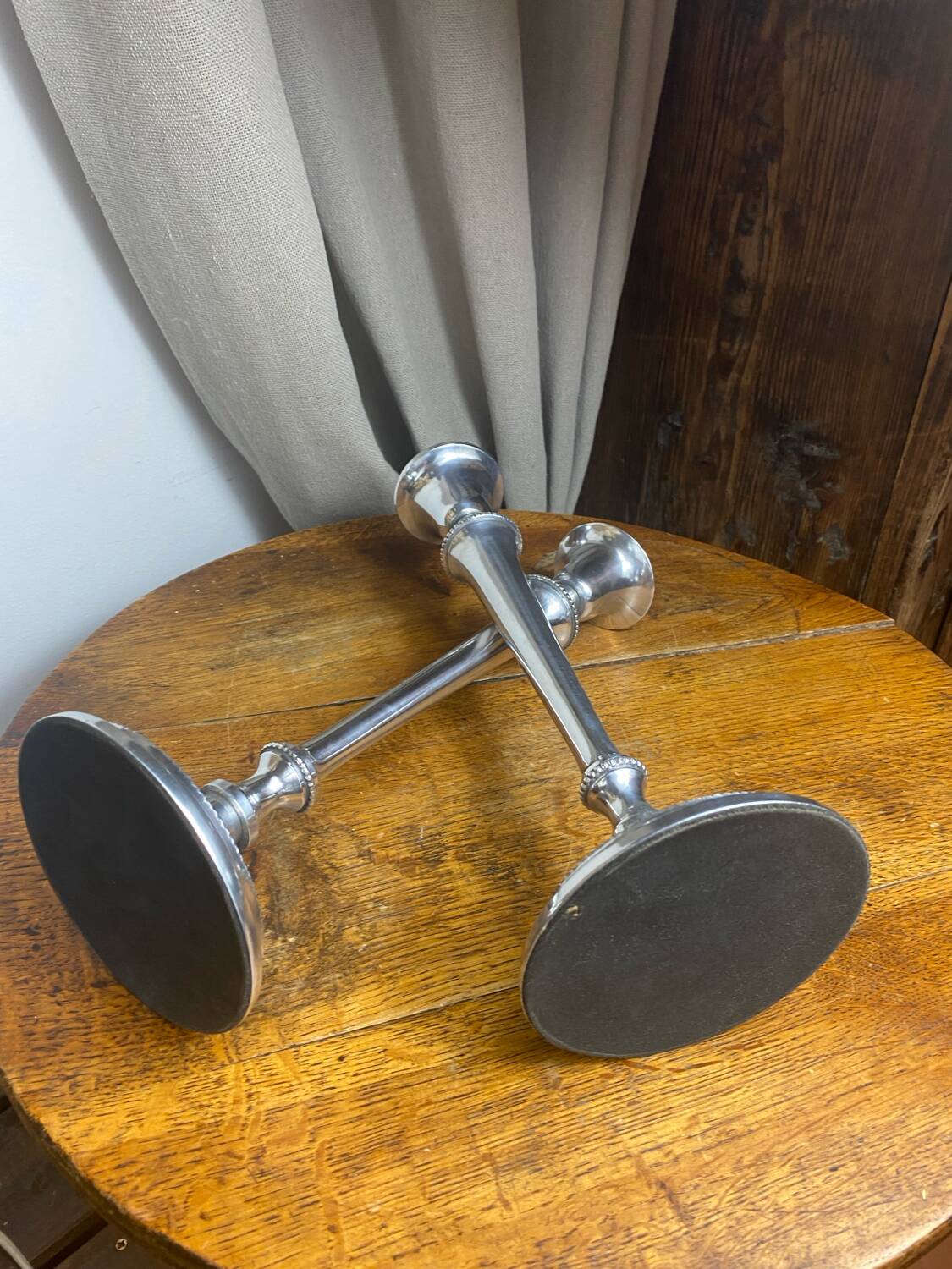 Pair of silver-plated metal candlesticks