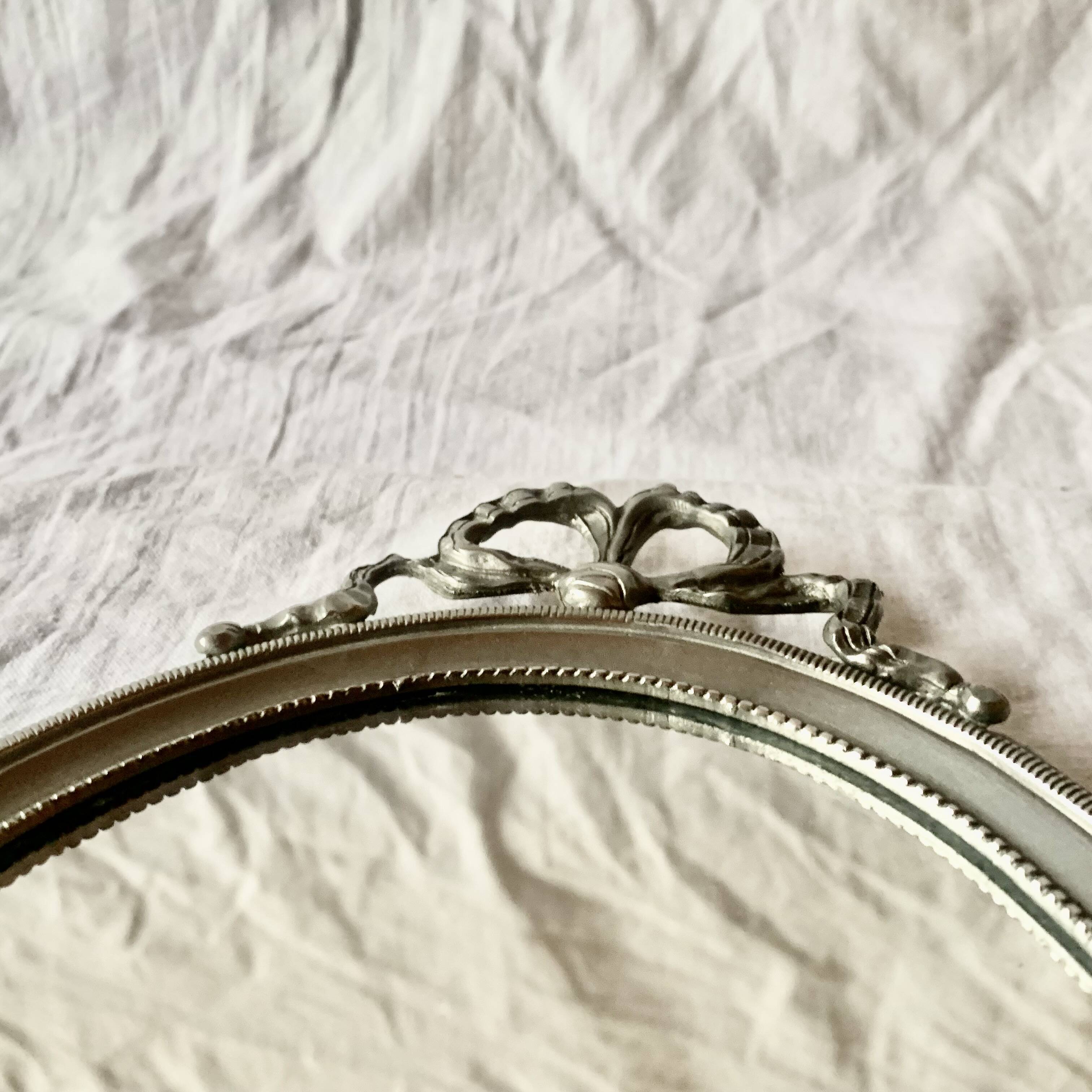 Louis XVI style oval metal wall mirror