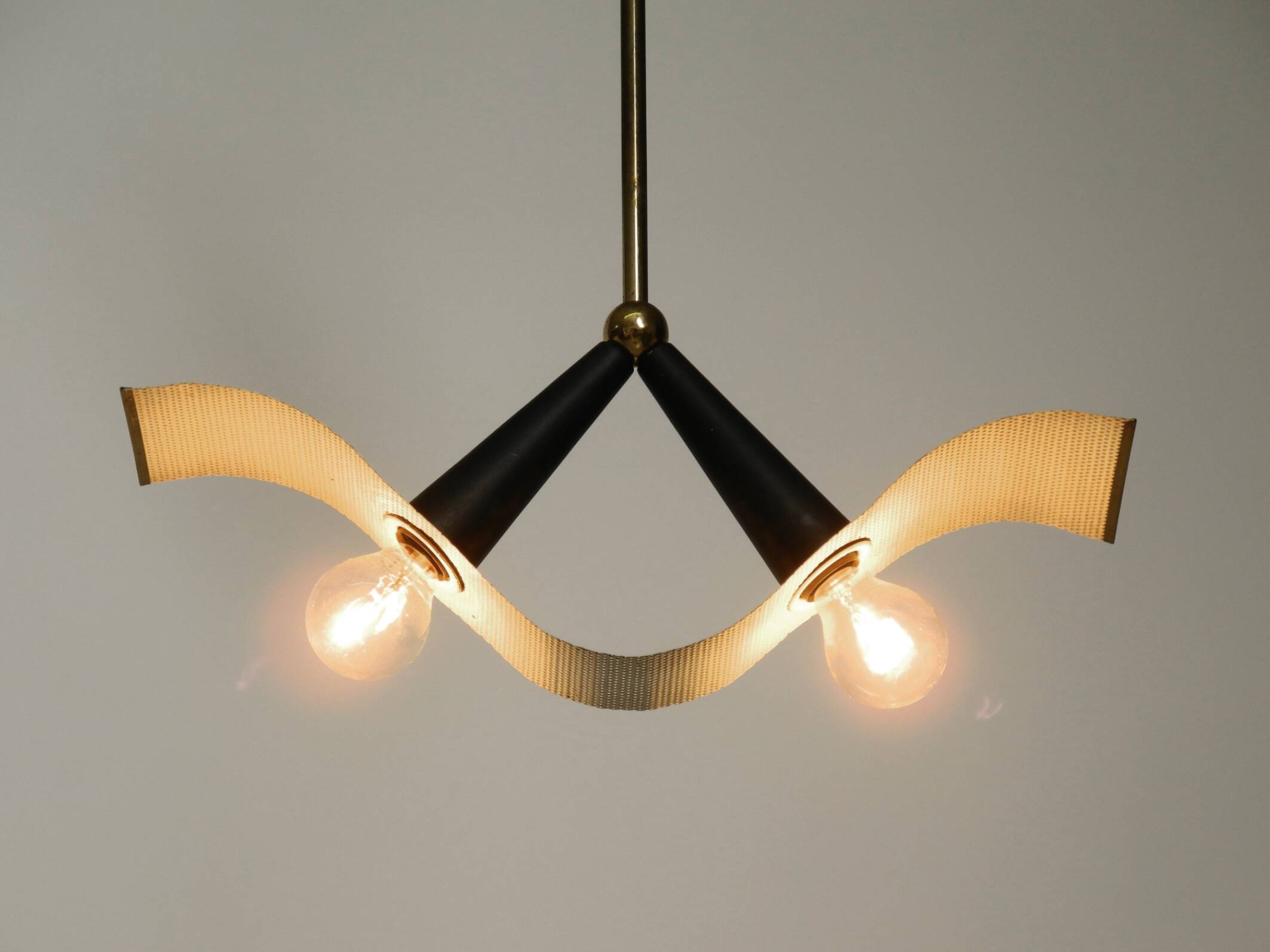 Mid Century brass ceiling lamp with a curved perforated sheet lampshade