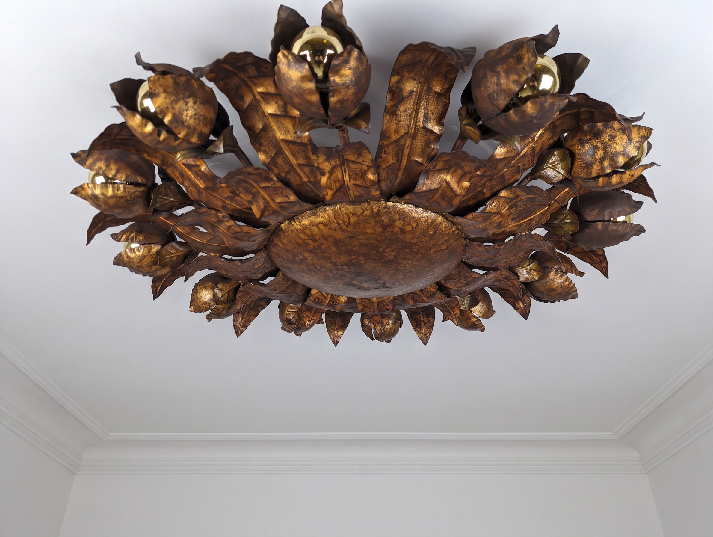 Large mid-century sunburst ceiling lamp, gilded metal with floral motif, 1950s
