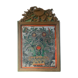 Miroir en bois sculpté et bronziné et verre eglomisé