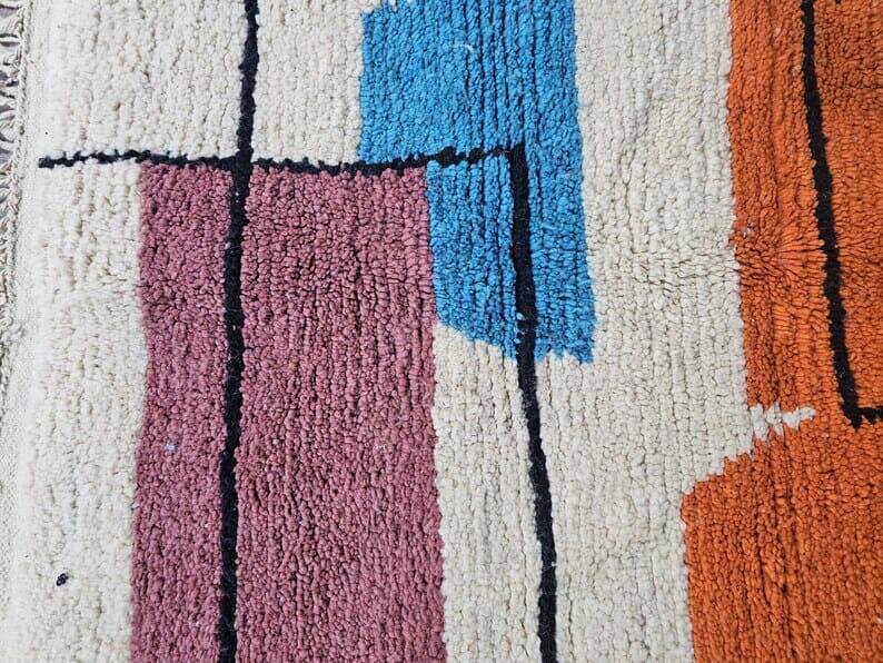 Traditional handmade wool Berber rug with colourful patterns.