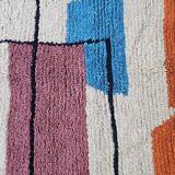 Traditional handmade wool Berber rug with colourful patterns.
