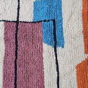 Traditional handmade wool Berber rug with colourful patterns.