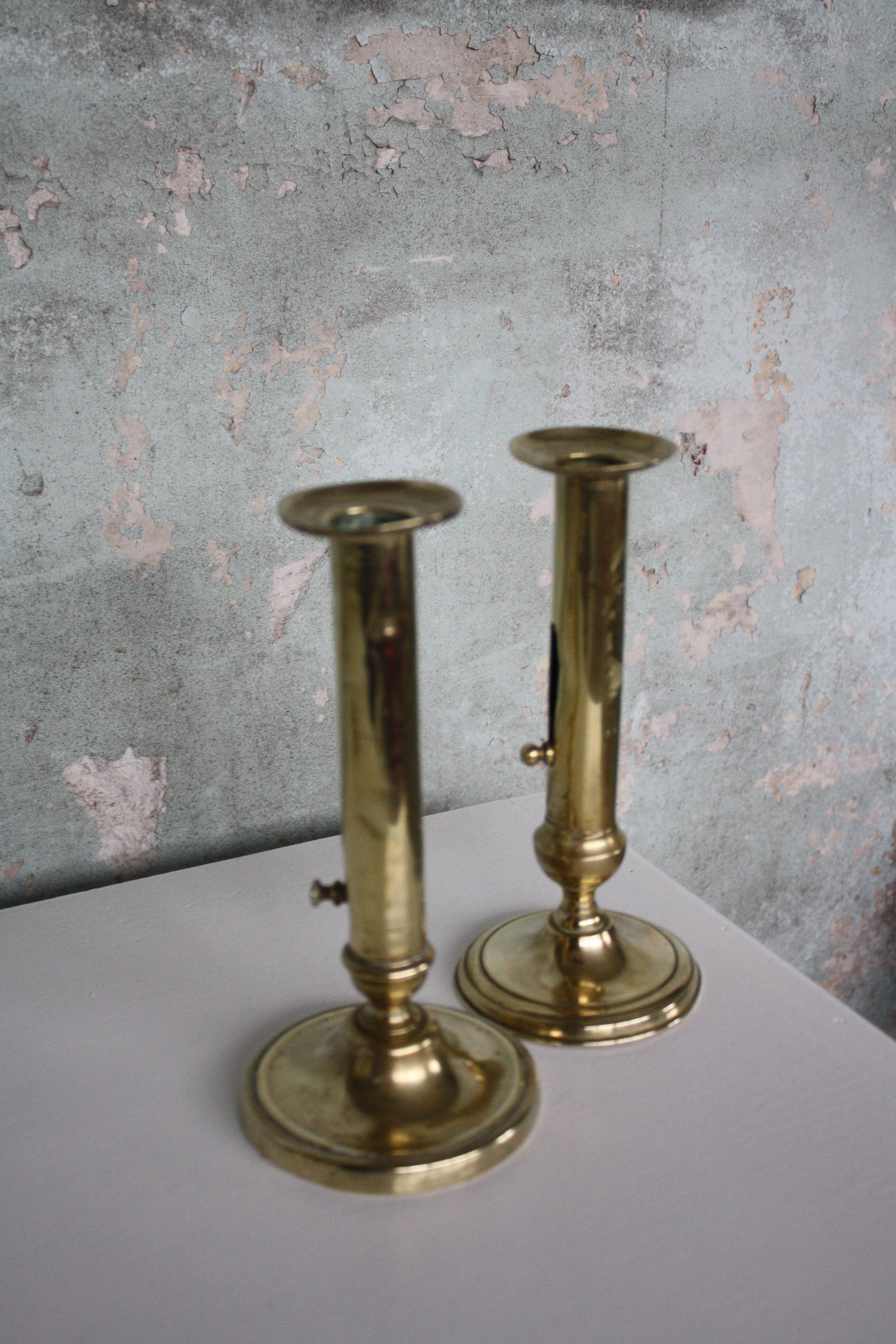 Pair of brass push-up candlesticks
