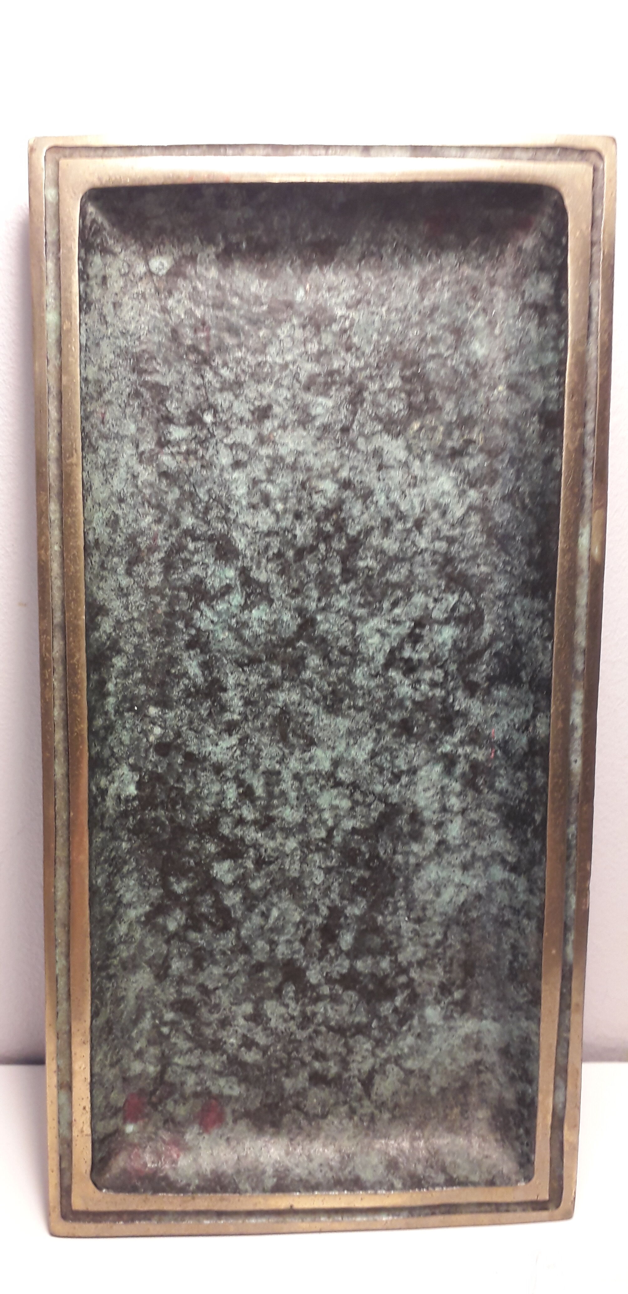 Empty top rectangular pocket in green patinated bronze