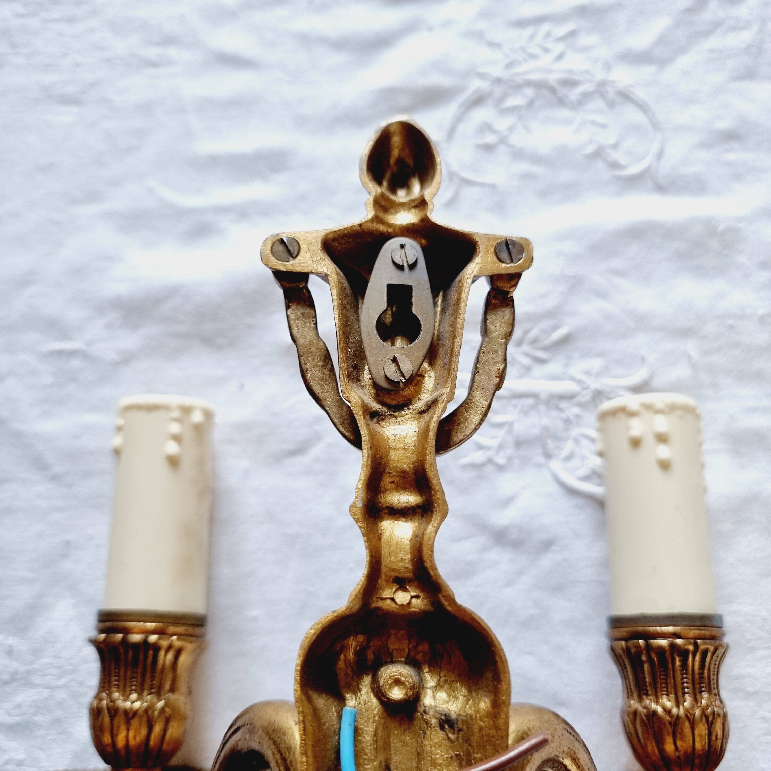 French Empire-style wall sconce or chandelier in bronze with an antique gold patina.