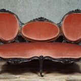 Very large Louis XV style mahogany banquette with medallions from the 19th century.