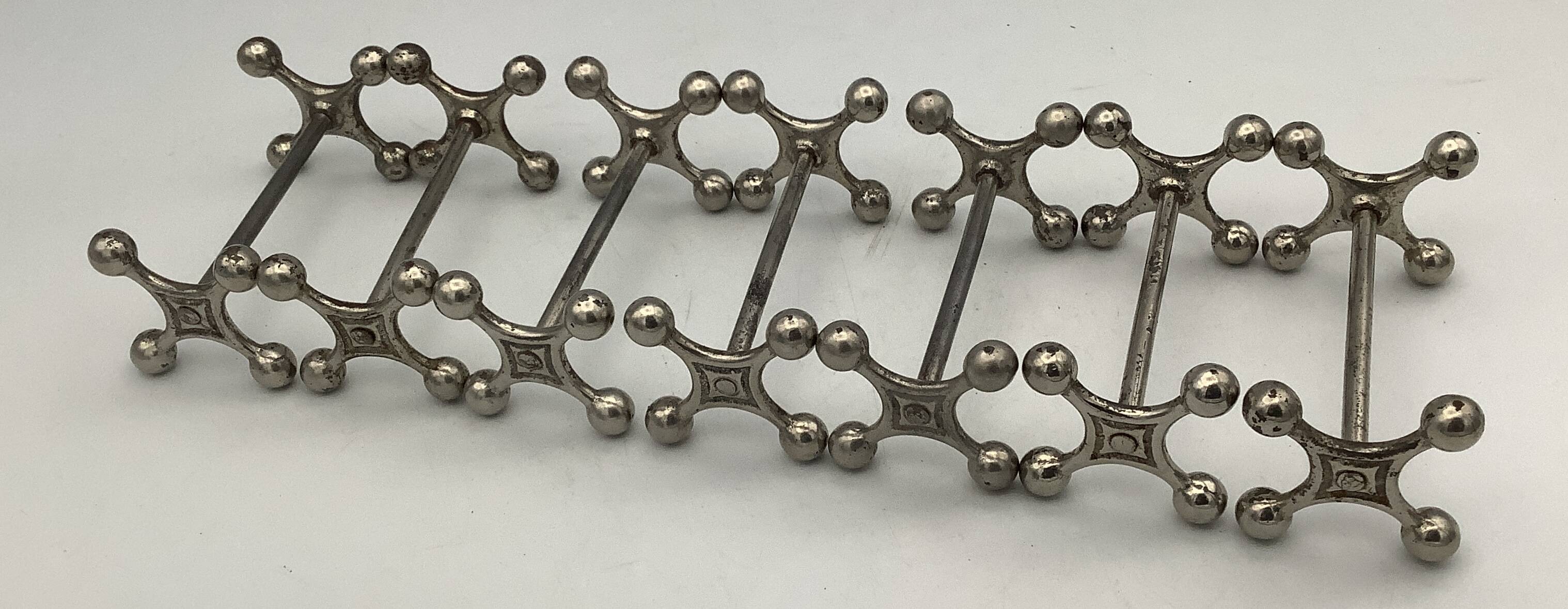 Set of 7 vintage knife rests in the shape of crosses in silver-plated metal.