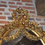 Golden oval mirror with a bow and a flower crown