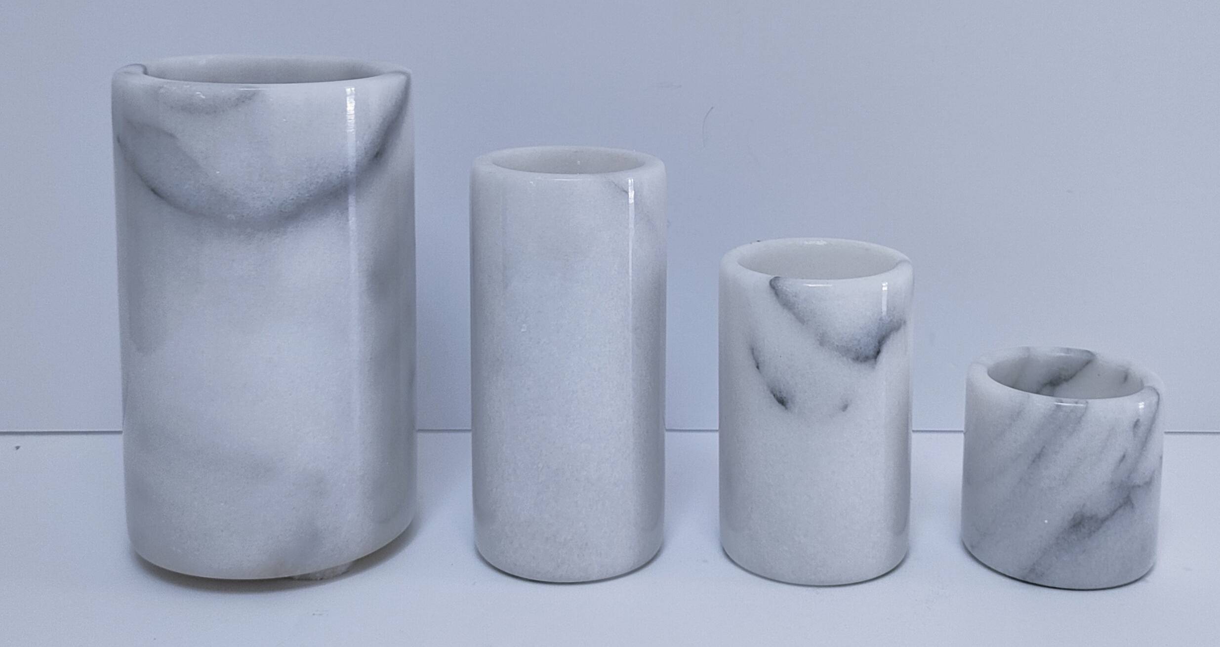 Four white marble candlesticks with black veins, 70s design